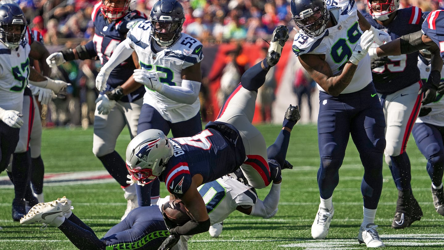 Antonio Gibson is upended as he dives for extra yardage. Gibson finished with 96 rushing yards in Sunday's loss.