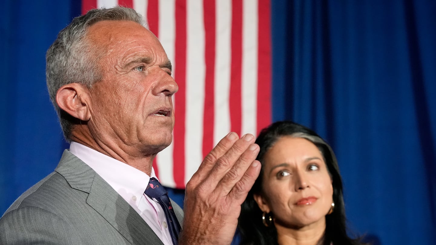 Robert F. Kennedy, Jr. answers a question as former Democratic Representative Tulsi Gabbard listens as they meet with the media after a campaign event for former president Donald Trump, Sept. 14, in Glendale, Ariz.