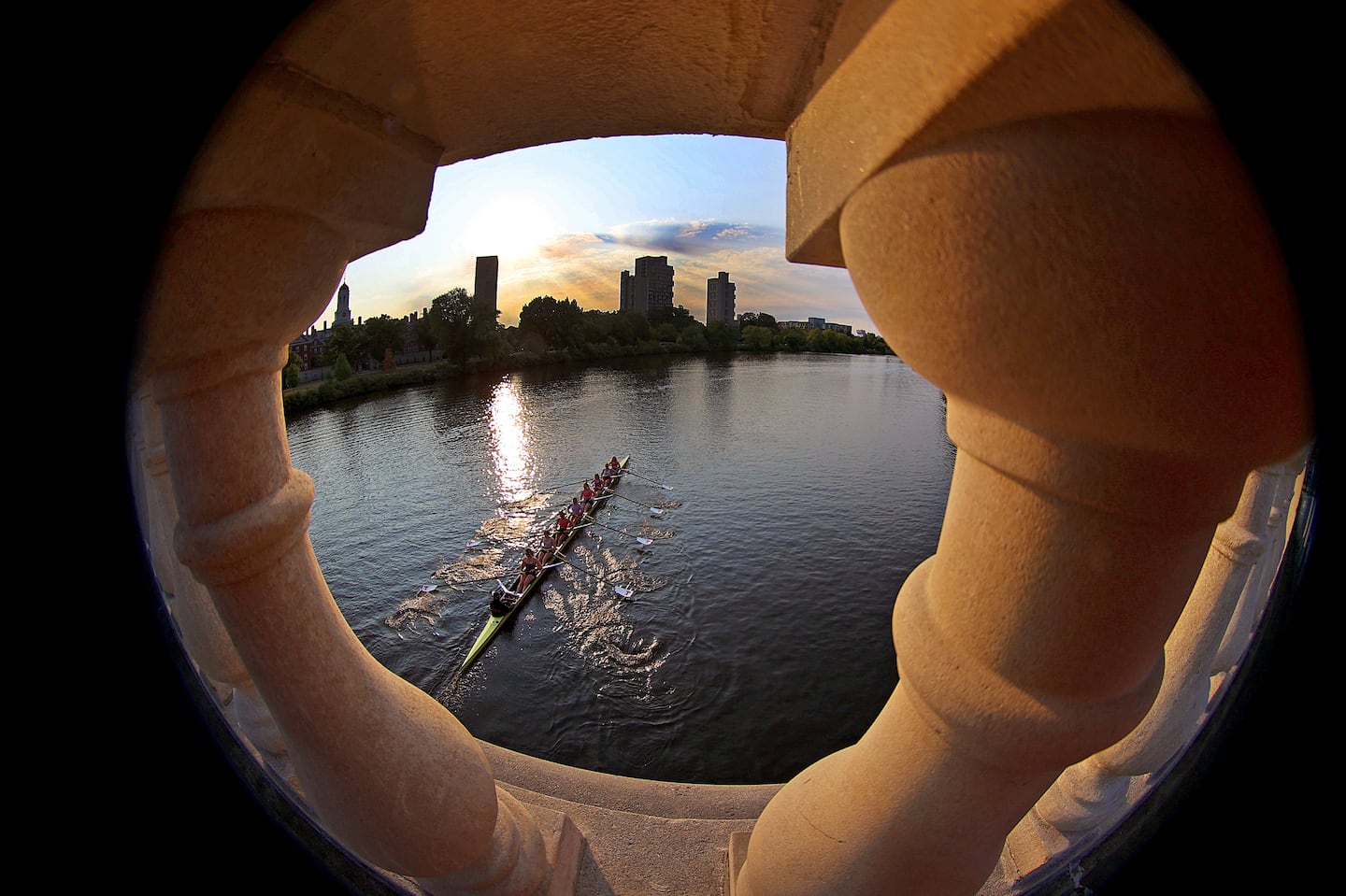 Early-morning rowers on the Charles River near Harvard University pass under the John W. Weeks Footbridge.