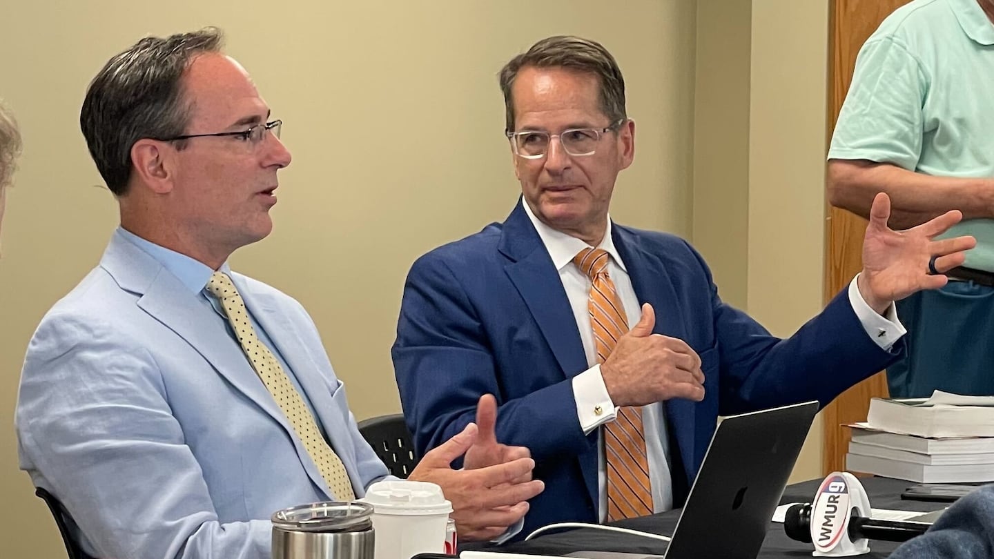 Drew Cline (left), president of the New Hampshire Board of Education, and Frank Edelblut, education commissioner for New Hampshire, discuss the PragerU course during a meeting of the state Board of Education in Concord, N.H., on Aug. 10, 2023.