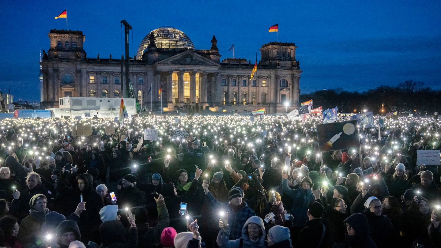 People held up their cellphones as they protested against the AfD party and right-wing extremism in front of the Reichstag building in Berlin on Jan. 21.