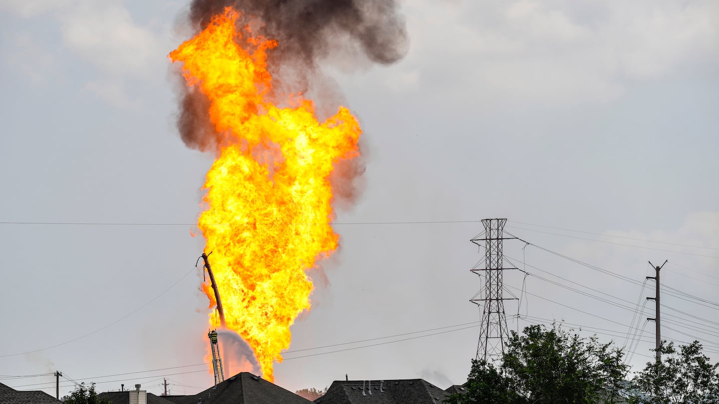 A firefighter directed a line of water around a fire on a pipeline carrying liquified natural gas near Spencer Highway and Summerton on Monday in La Porte, Texas.