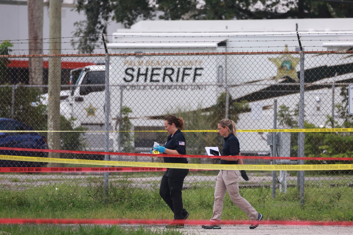 Law enforcement personnel continue to investigate the area around Trump International Golf Club Monday after an apparent assassination attempt on former president Donald Trump in West Palm Beach, Fla.