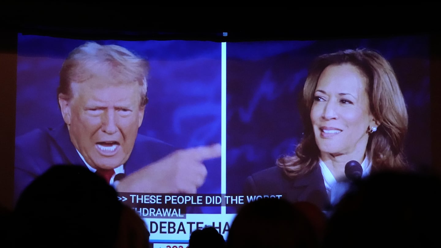 Republican presidential nominee former president Donald Trump, left, and Democratic presidential nominee Vice President Kamala Harris are seen on a screen during a presidential debate as people watched in Portland, Maine.