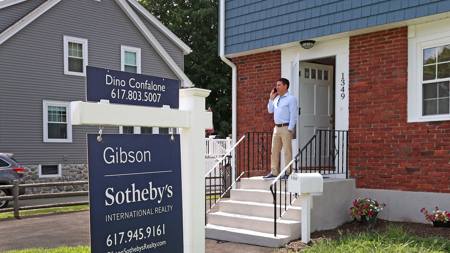 Realtor Dino Confalone waited to show a Braintree home to a client in August. The median price for a single-family home inched down slightly last month, though it's still higher than last year.