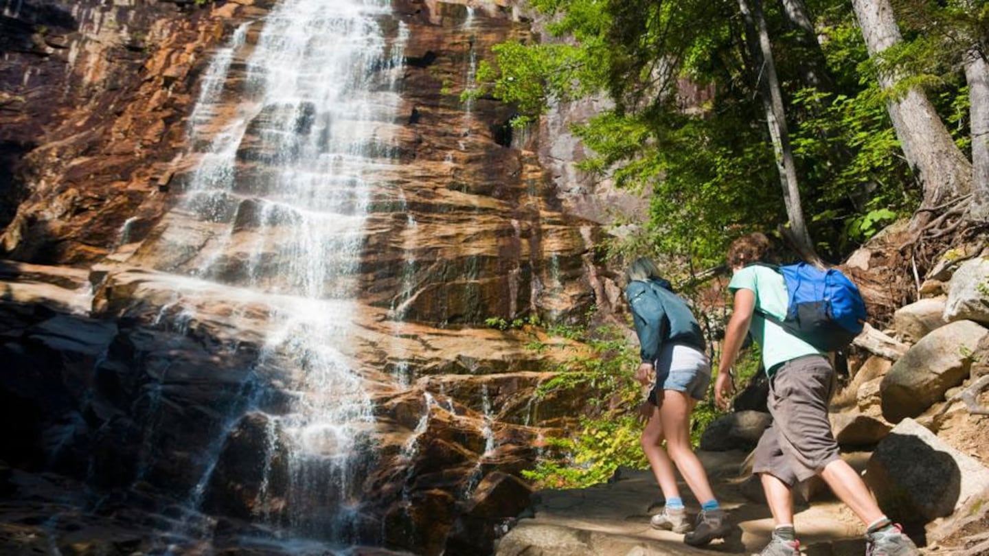 A couple hiking at Arethusa Falls in Crawford Notch State Park in New Hampshire's White Mountains.