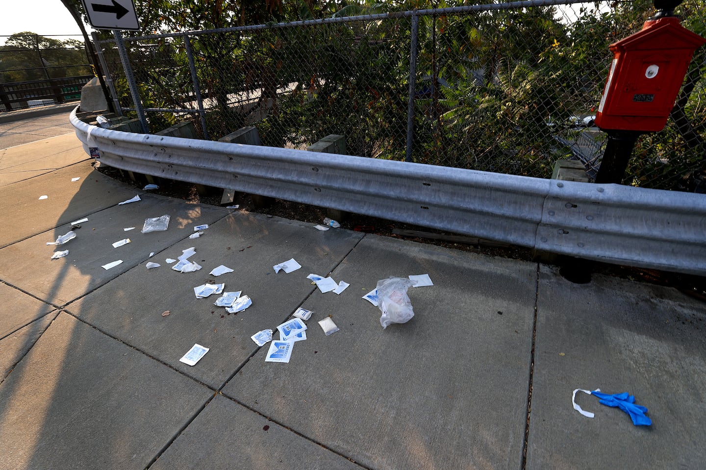 The scene of last week's shooting near 701 Washington St. in Newton, with emergency EMS material left on the sidewalk.