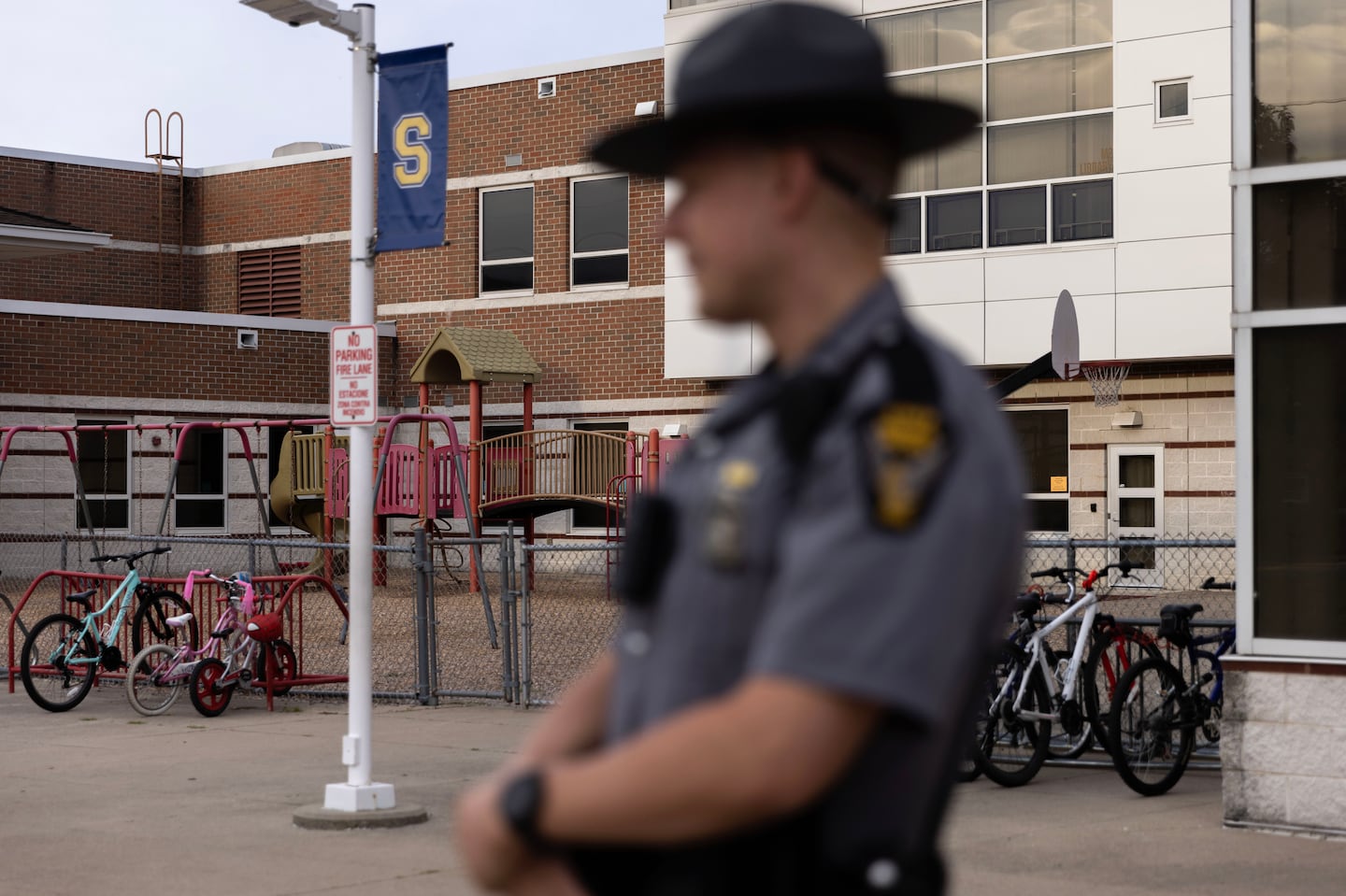 An Ohio state trooper stood guard at Snowhill Elementary School in Springfield, Ohio, on Sept. 17. Governor Mike DeWine of Ohio announced Monday that he was deploying state troopers to the city of Springfield to reassure the community that schools are safe despite a wave of bomb threats.