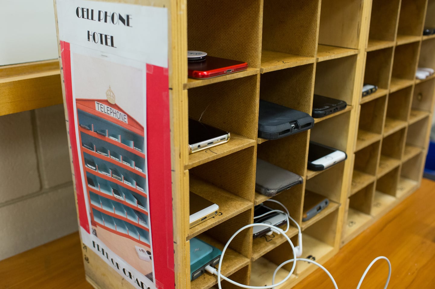 Cell phones fill the phone hotel in Gerry Padilla's Spanish class at Marlborough High School in Marlborough, Massachusetts on May 1, 2018. Students place their phones in one of the numbered cubby holes at the start of class and can retrieve them at the end of class. Cell phone use is not allowed in the classroom.