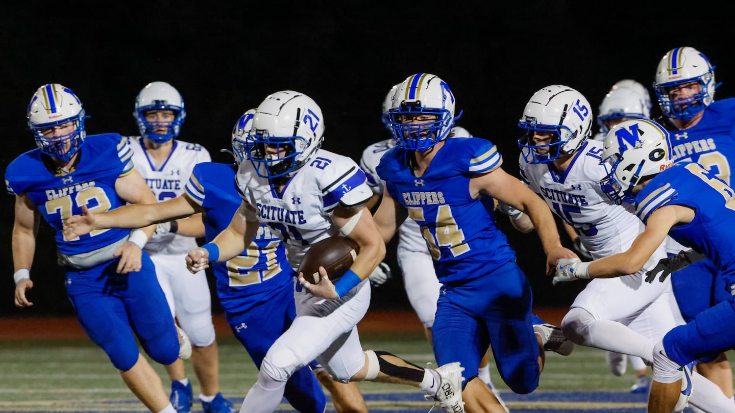 Scituate running back Willy Robinson (No. 21) makes a break for it, leaving Norwell's defense in his wake in the first half of Thursday night's 41-6 nonleague victory at Norwell High.