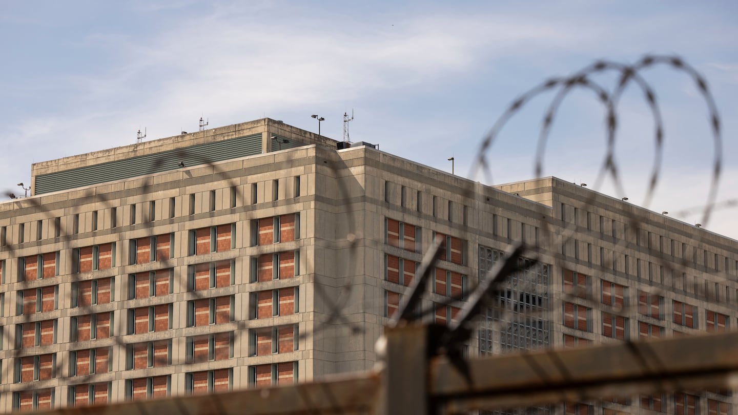 The Metropolitan Detention Center is seen through barb wire in the Sunset Park neighborhood of the Brooklyn borough of New York, Thursday, Sept. 19, 2024.