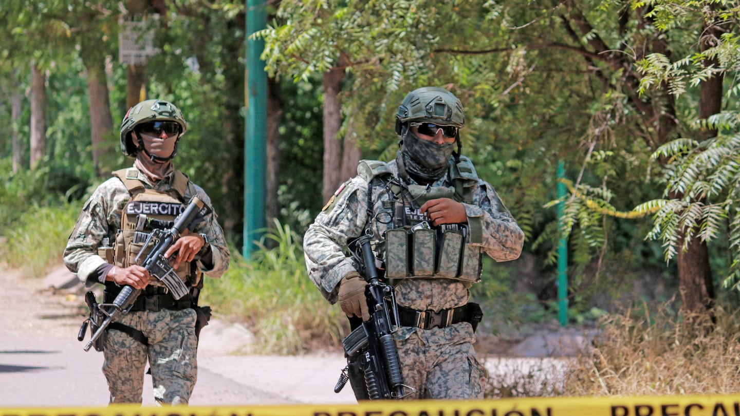 Soldiers of the Mexican Army stood guard as they secured an area during a military operation in Culiacan, Sinaloa State, Mexico, on Thursday. Military forces and the National Guard carried out an operation in the Jardines de Santa Fe sector, Culiacan, whilst searching for "El Piyi," an important member of the Sinaloa Cartel, close to a criminal group known as Los Chapitos.