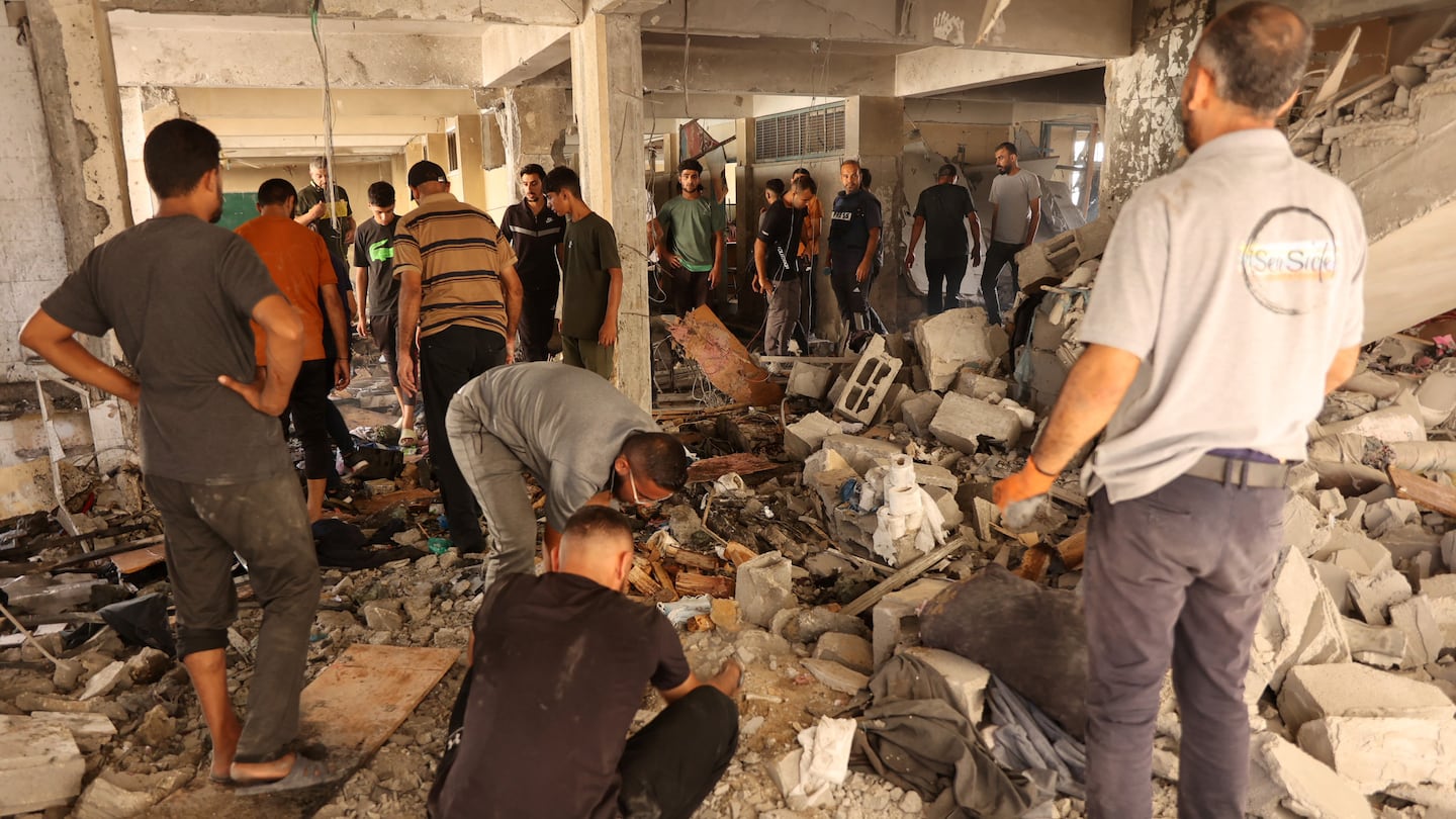 Palestinians inspected damage at the site of an Israeli strike on a school on Saturday in Gaza. Israel's military said it targeted Hamas militants.