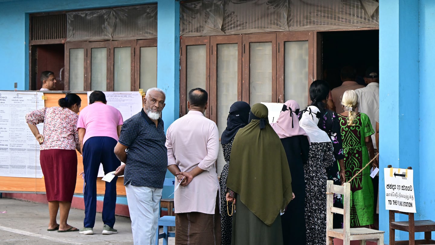 People wait in line to enter a polling station during voting in Sri Lanka's presidential election in Colombo on September 21, 2024.