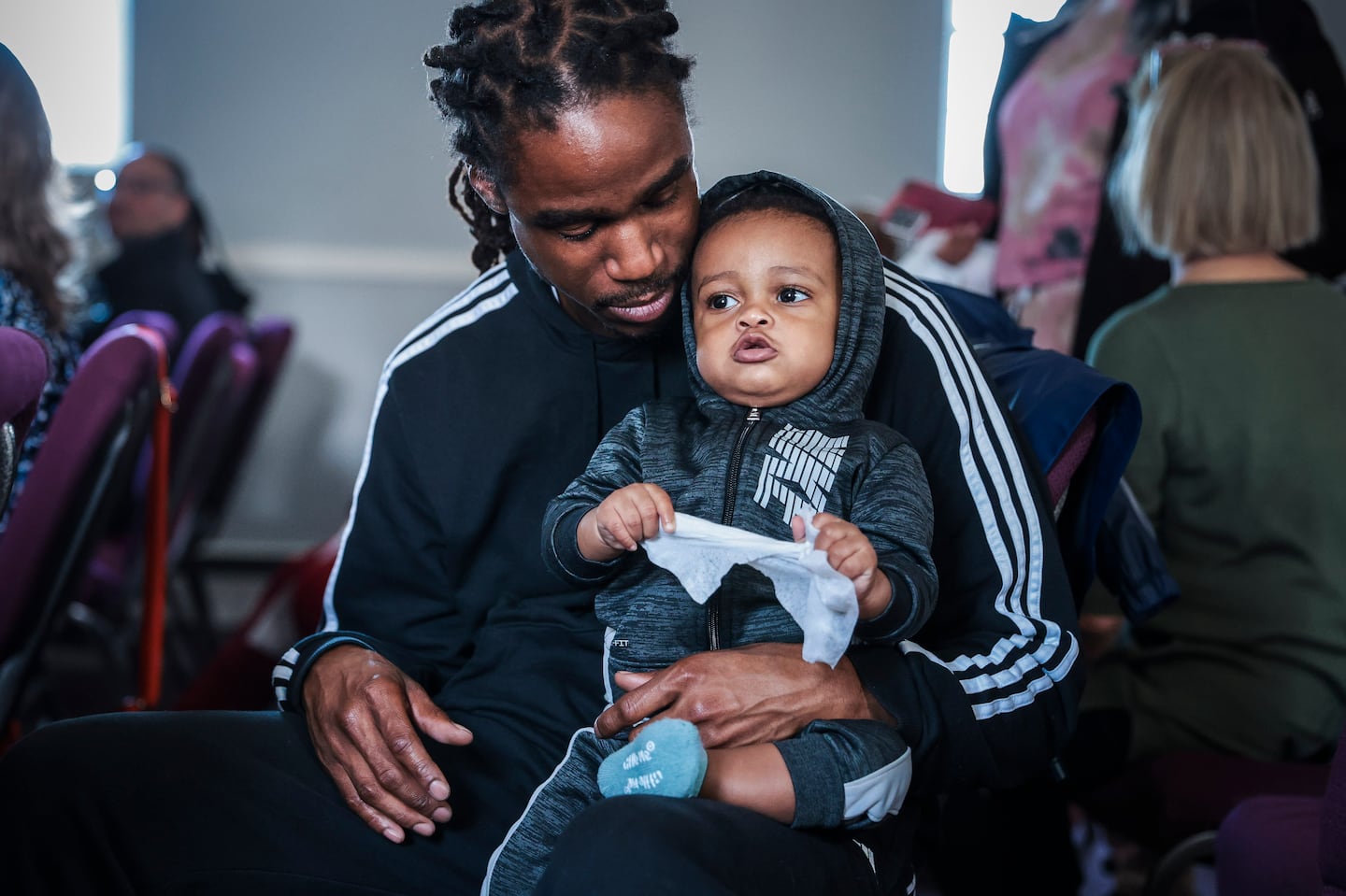 Eric Anderson, director of communications and special projects at the Transformational Prison Project, held his 11-month-old son Marcel on April 8, 2023, while attending the first meeting of We Are Joint Venture, a group of individuals who gather together to focus on sentence parity in the Massachusetts criminal law system. Founded and led by a group of men at MCI-Norfolk, We Are Joint Venture focuses on creating a network of information about the criminal law system.