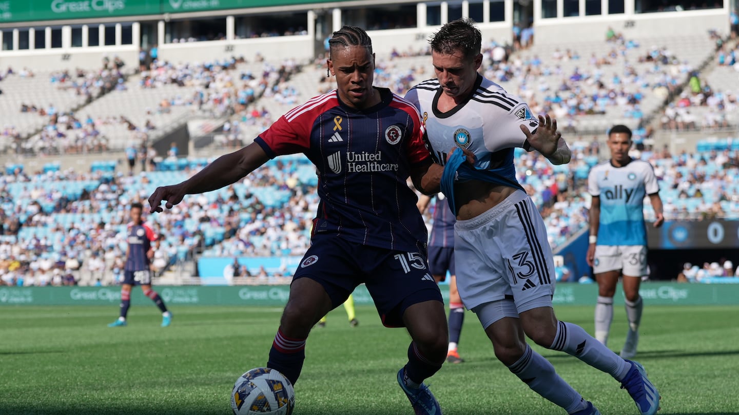 The Revolution's Brandon Bye battles with Charlotte's Brandt Bronico during Saturday's match in Charlotte, N.C.