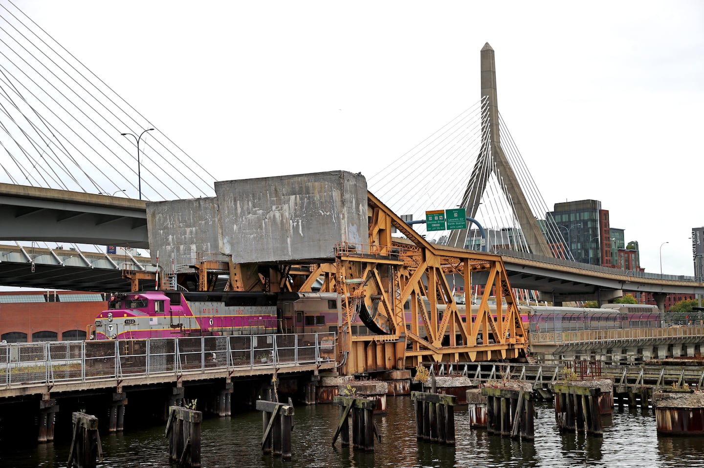 A commuter rail train traveled through the North Station Draw One Bridge on Monday. The MBTA has won its largest federal award to date from the US Department of Transportation to replace the bridge.