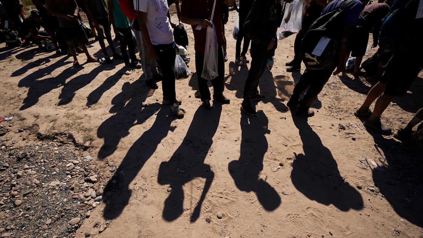 Migrants waited to be processed by the US Customs and Border Patrol after they crossed the Rio Grande in October 2203 in Eagle Pass, Texas.