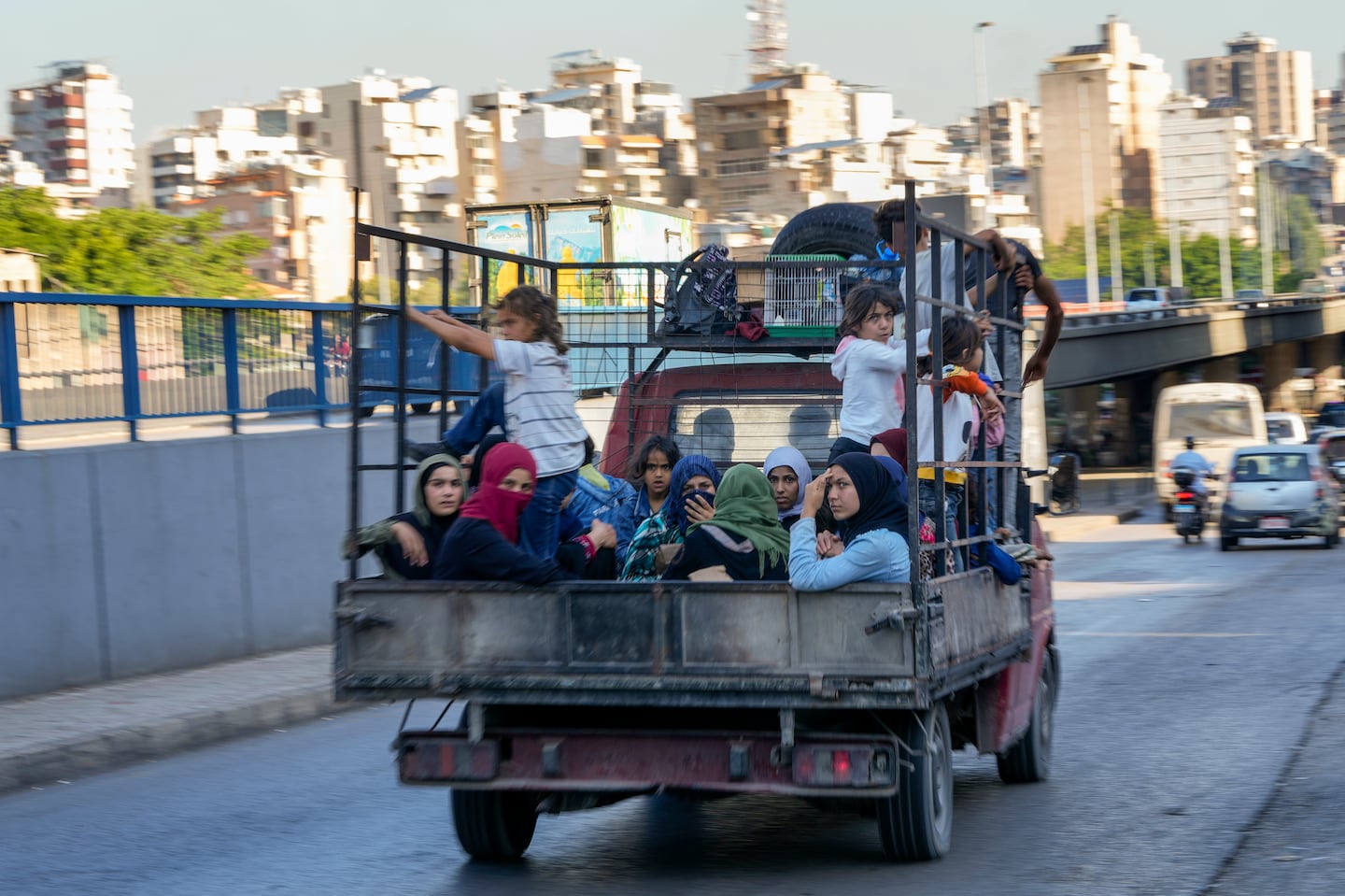 Lebanese citizens who fled from the southern villages amid ongoing Israeli airstrikes Monday sat in a pickup in Beirut on Tuesday.