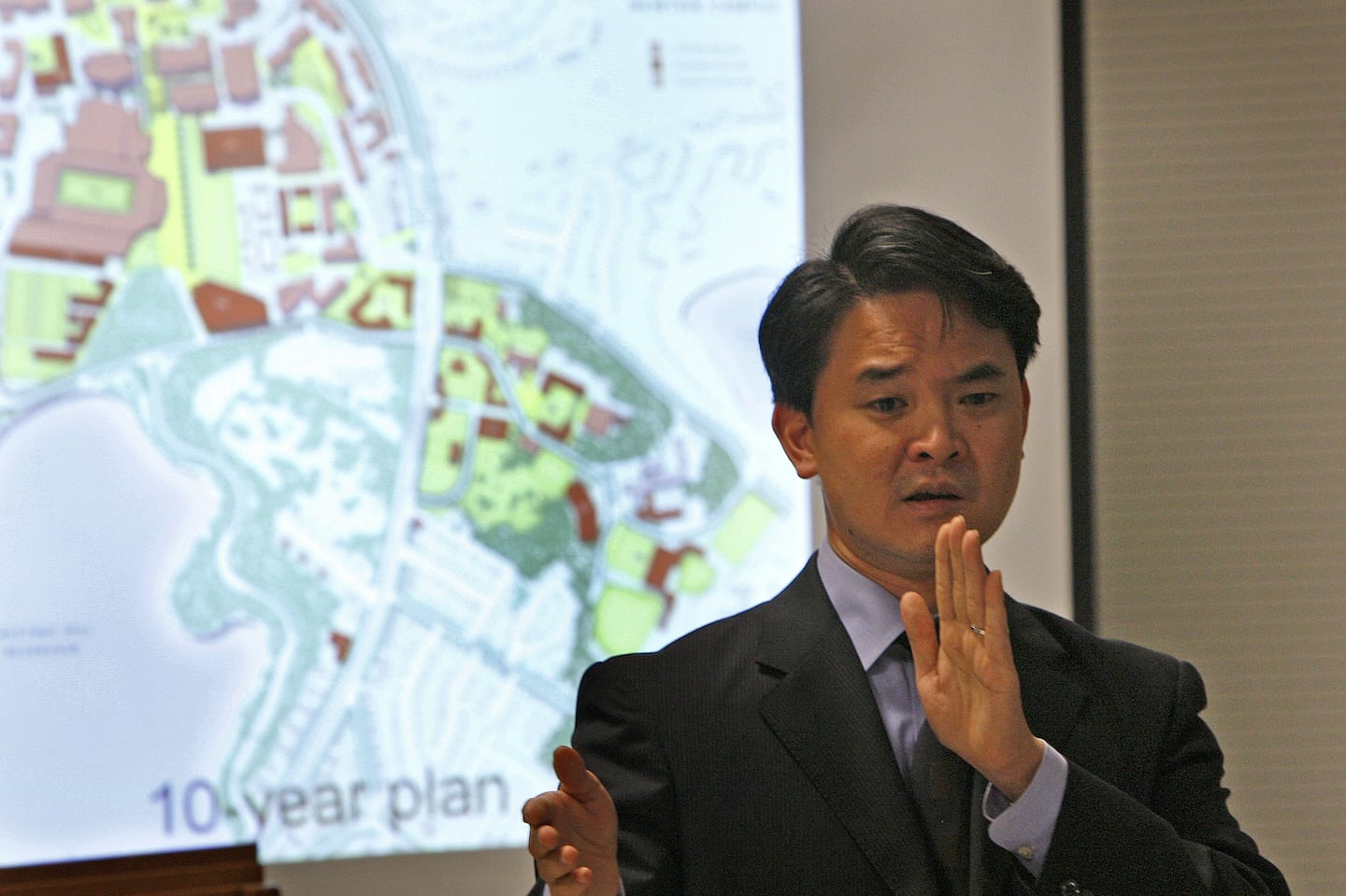 Kairos Shen, seen here in 2008 when he was director of planning for the Boston Redevelopment Authority, speaking at a meeting, at Brighton Marine Health Center, with Boston College officials and concerned neighbors regarding BC's proposed development plans.