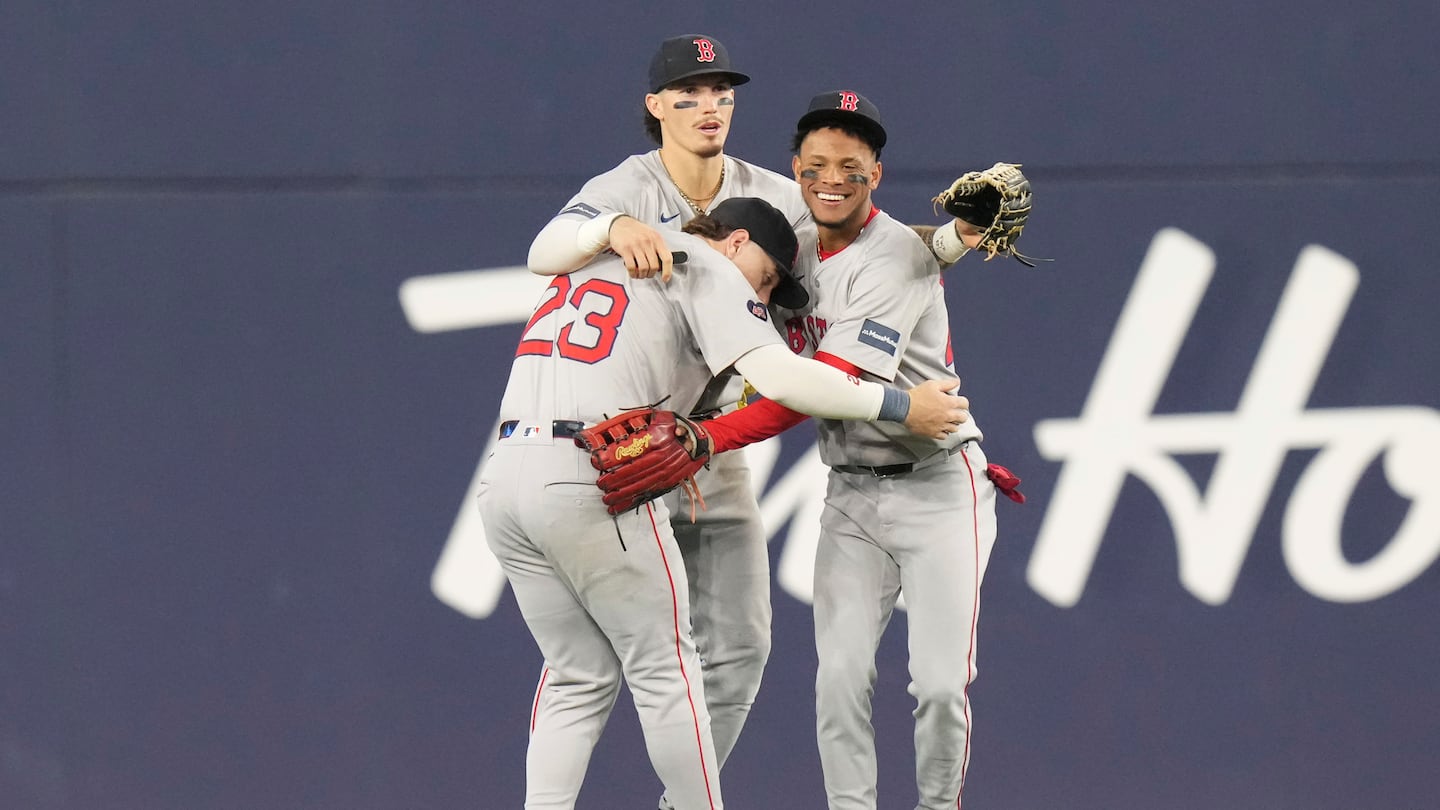 Jarren Duran (center) celebrates with Romy Gonzalez (23) and Ceddanne Rafaela after the Red Sox defeated the Blue Jays, 6-5 in 10 innings.