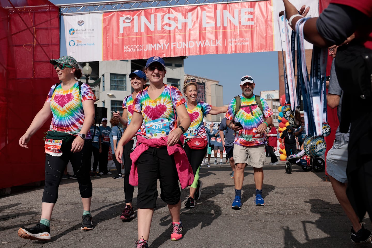 People smiled after crossing the finish line during the 2023  Boston Marathon Jimmy Fund Walk. This year, construction in Copley Square has led to the finish line for the Oct. 6 walk be moved to Boston Common.