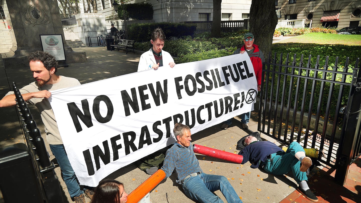 Extinction Rebellion protestors locked themselves to the General Hooker entrance at the State House in September.