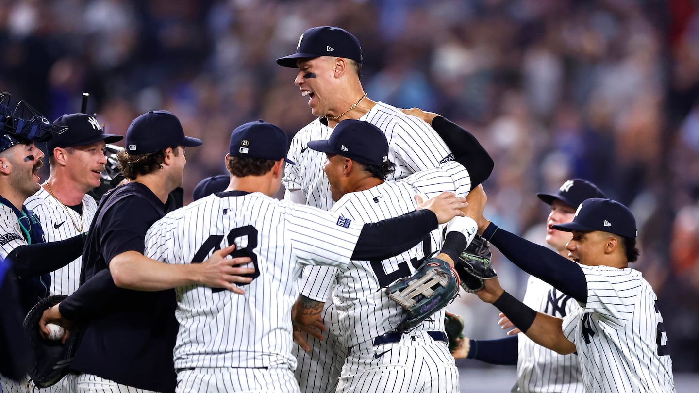 The Yankees, with Aaron Judge of course the big man in the middle, celebrate after clinching the AL East title with a 10-1 win over the Orioles Thursday night in New York.