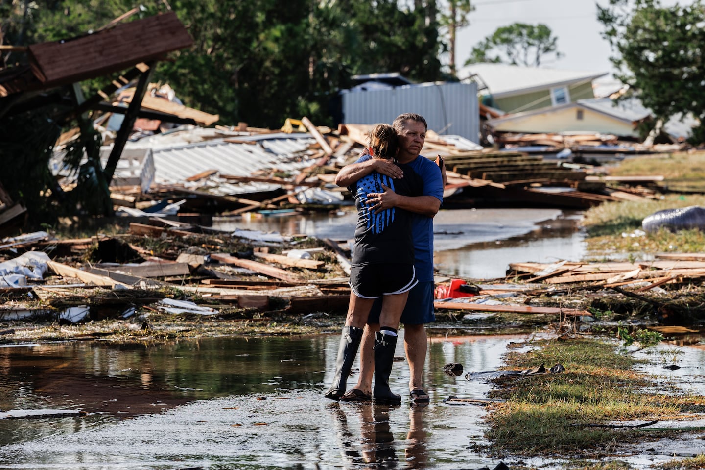 James High hugged his wife, Leslie High, after arriving in their neighborhood to discover most of the homes there destroyed by Hurricane Helene in the small community of Dekle Beach near Keaton Beach, Fla., on Friday.