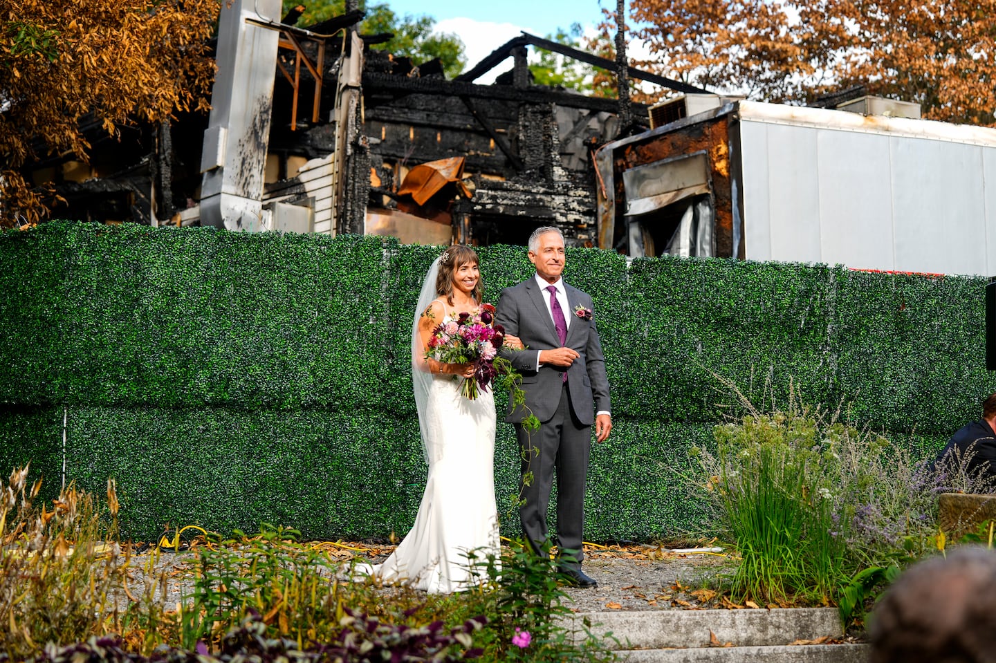 Kali Vitek walked down the aisle with her father, Donald Vitek, during her wedding to Joey Espinola at the Herb Lyceum on Sept. 22 in Groton. The Herb Lyceum, a popular wedding venue, suffered a fire that destroyed the carriage house.