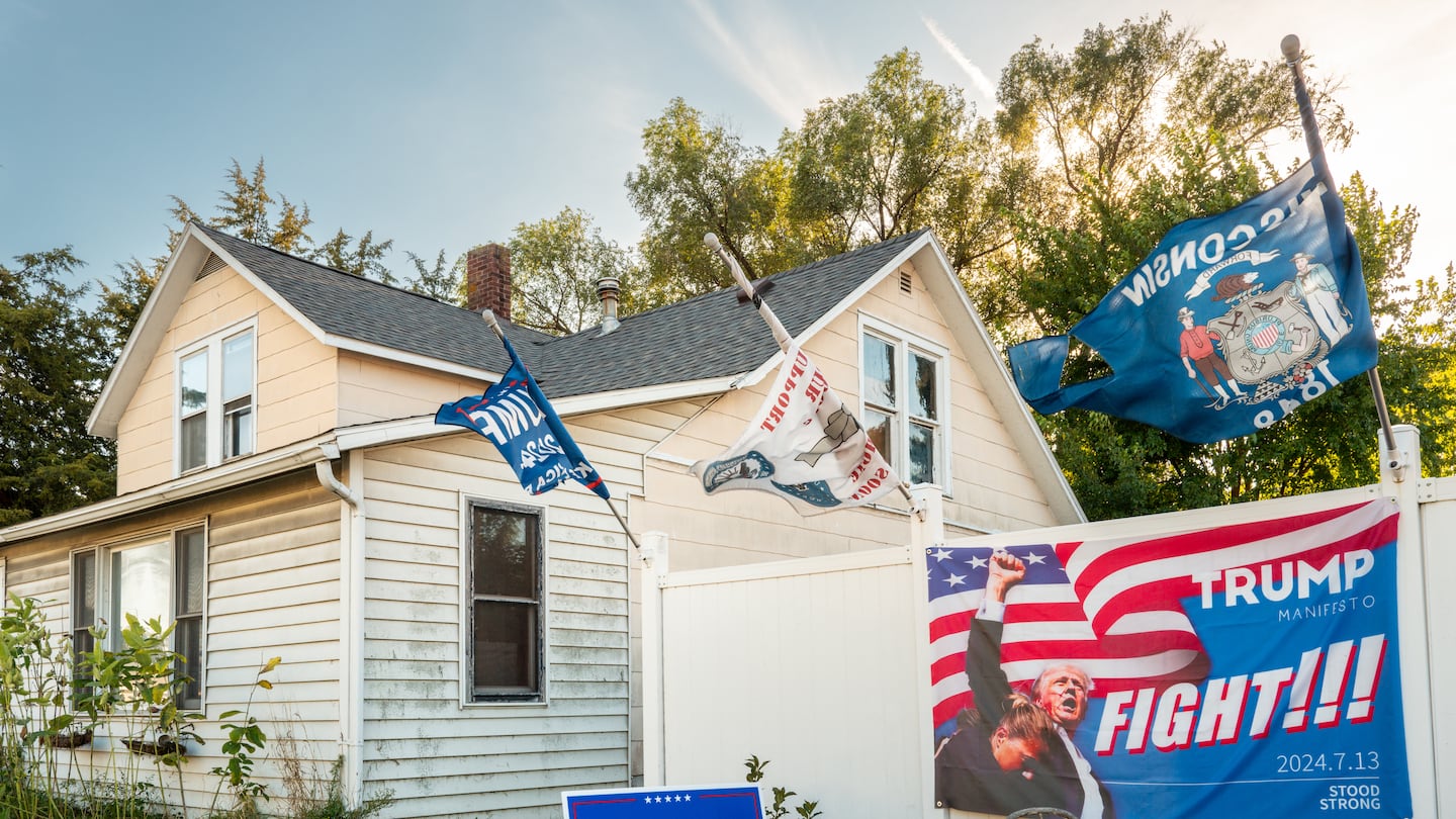 Campaign banners and posters in a front yard on Sept. 28, in Prairie du Chien, Wis.