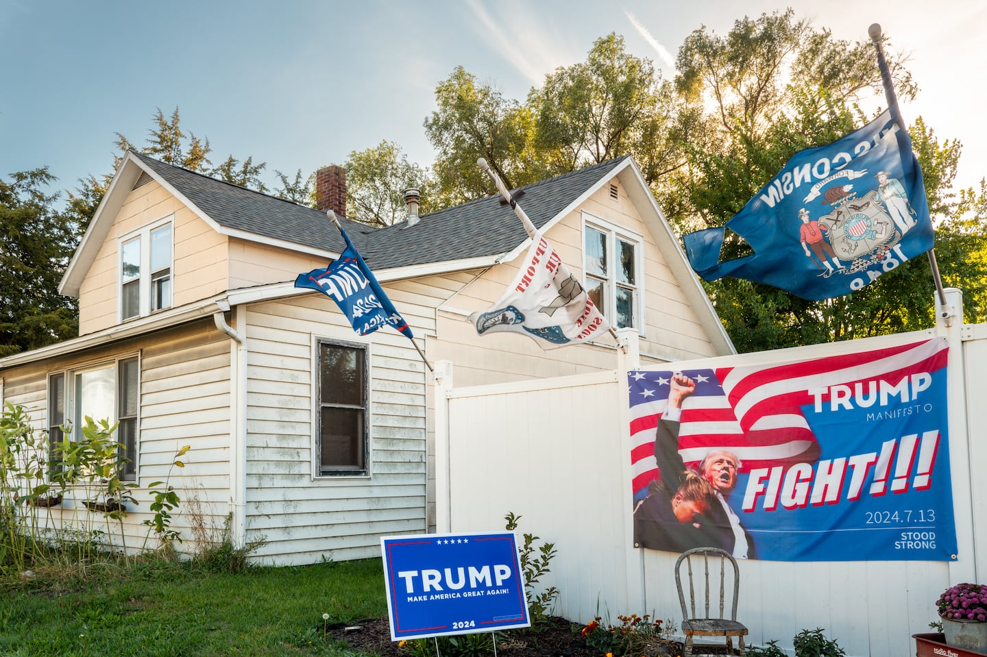 Campaign banners and posters in a front yard on Sept. 28, in Prairie du Chien, Wis.