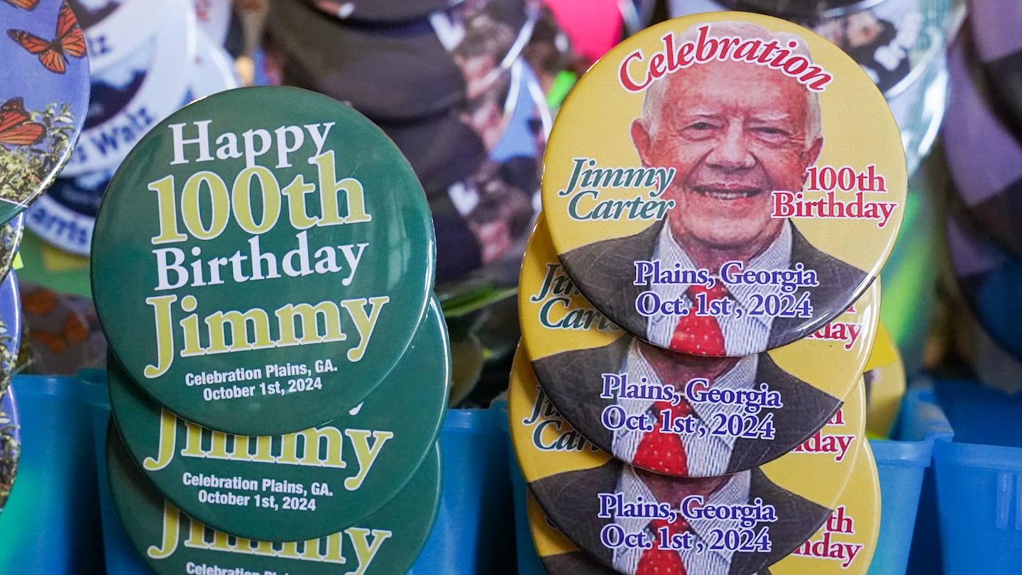 Badges celebrating former president Jimmy Carter were available at the Plains Peanut Festival on Saturday in Plains, Ga.