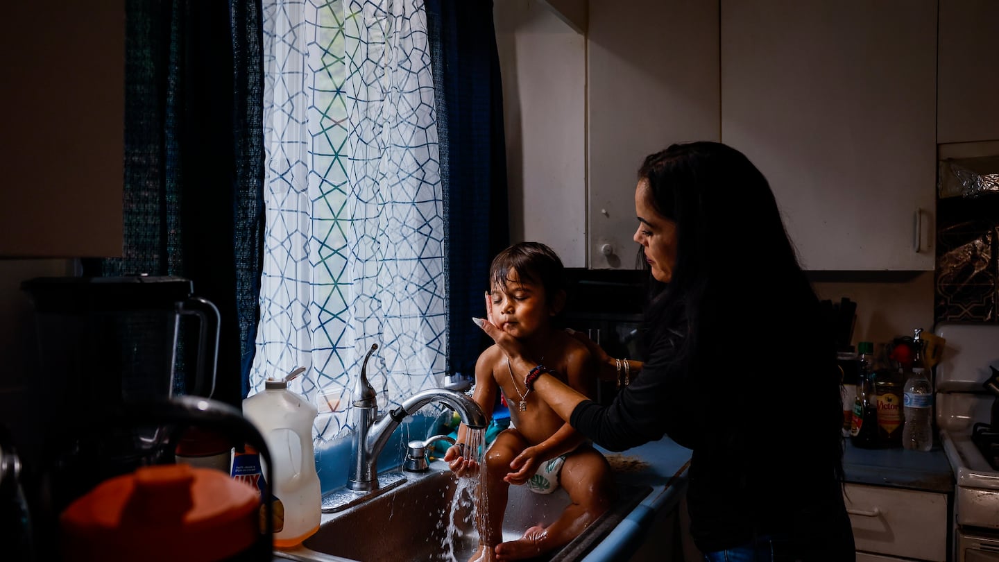 Gerrilee Thou rinsed her 2-year-old son, Ace, at the kitchen sink in their Malden home. Thou, a mother of six, is struggling to make ends meet while her husband, Vibol, is detained by immigration authorities.