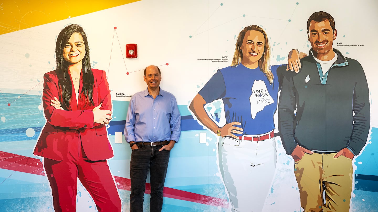 Warren Adams, the director of the newly launched ClimateTech incubator at the Roux Institute, stood at a wall mural in the office in Portland.