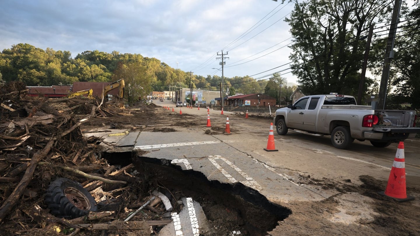 A motorist passes flood damage at a bridge in the aftermath of Hurricane Helene in Old Fort, North Carolina on Sept. 30.