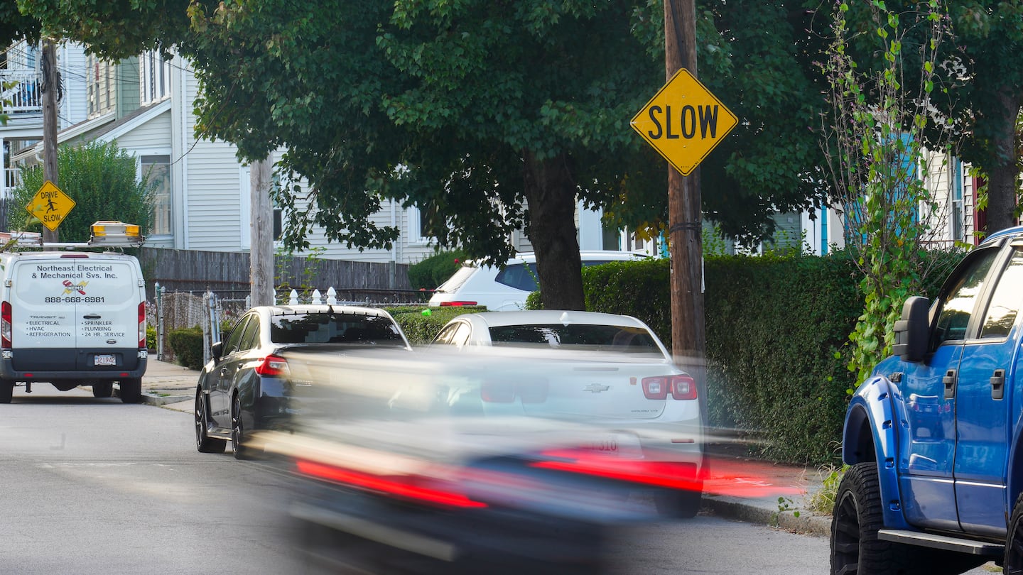 Vehicles pass eda slow sign installed on Glendower Road in Roslindale. Residents on this street were frustrated about the constant speeding that has resulted in multiple car crashes and damage to home and cars.