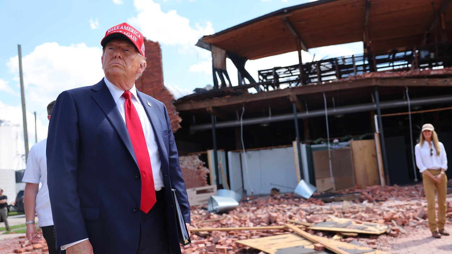 Former president Donald Trump listens to a question as he visits Chez What Furniture Store which was damaged during Hurricane Helene on Sept. 30, 2024 in Valdosta, Ga.