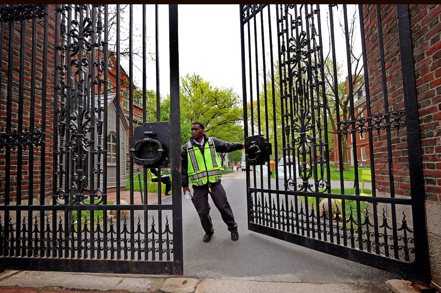 A Harvard security guard closed the Johnston Gate at Harvard University in May. Harvard is enforcing tighter restrictions on protesters this fall.