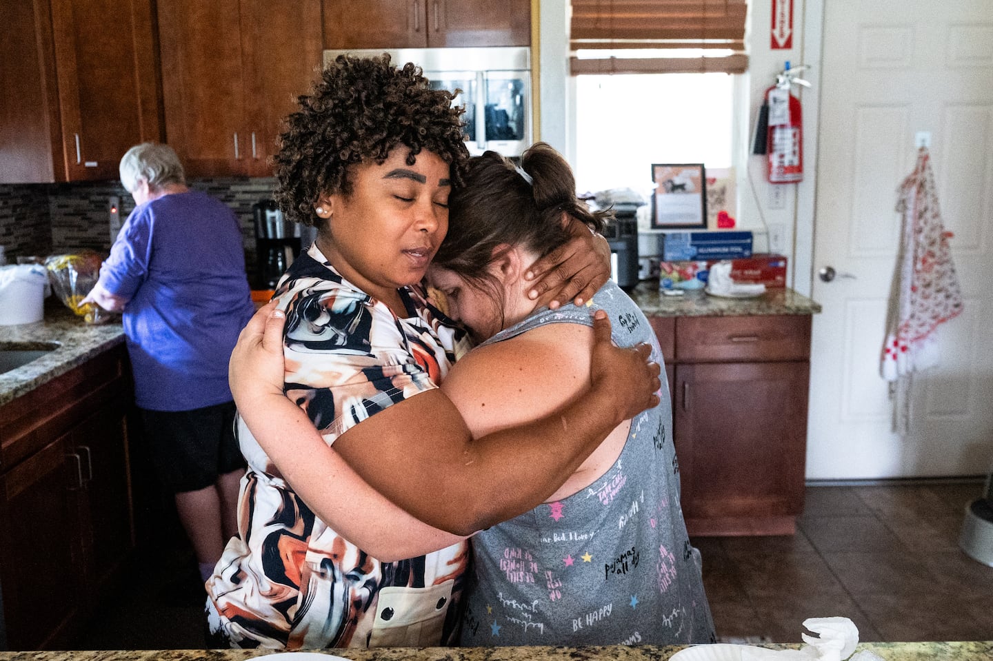 Sindy Micourt hugged resident Kristen Camacho at the Thrive Support and Advocacy center in Marlborough. Camacho was stressed about her irritated eye.