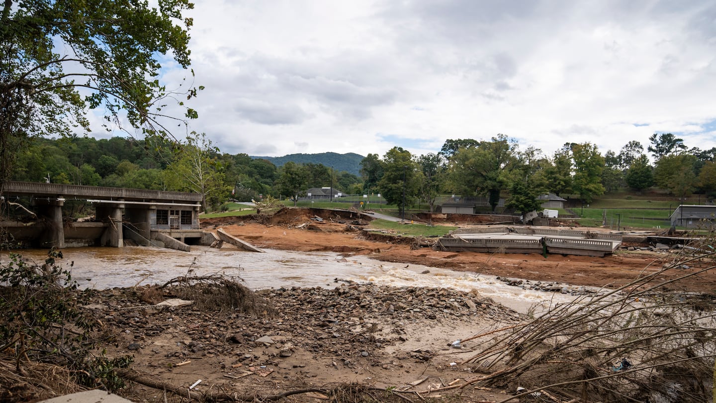 The collapsed Lake Craig dam on the Swannanoa River and a section of bridge washed to the Asheville Recreation Park, right, in Asheville, N.C., on Monday.