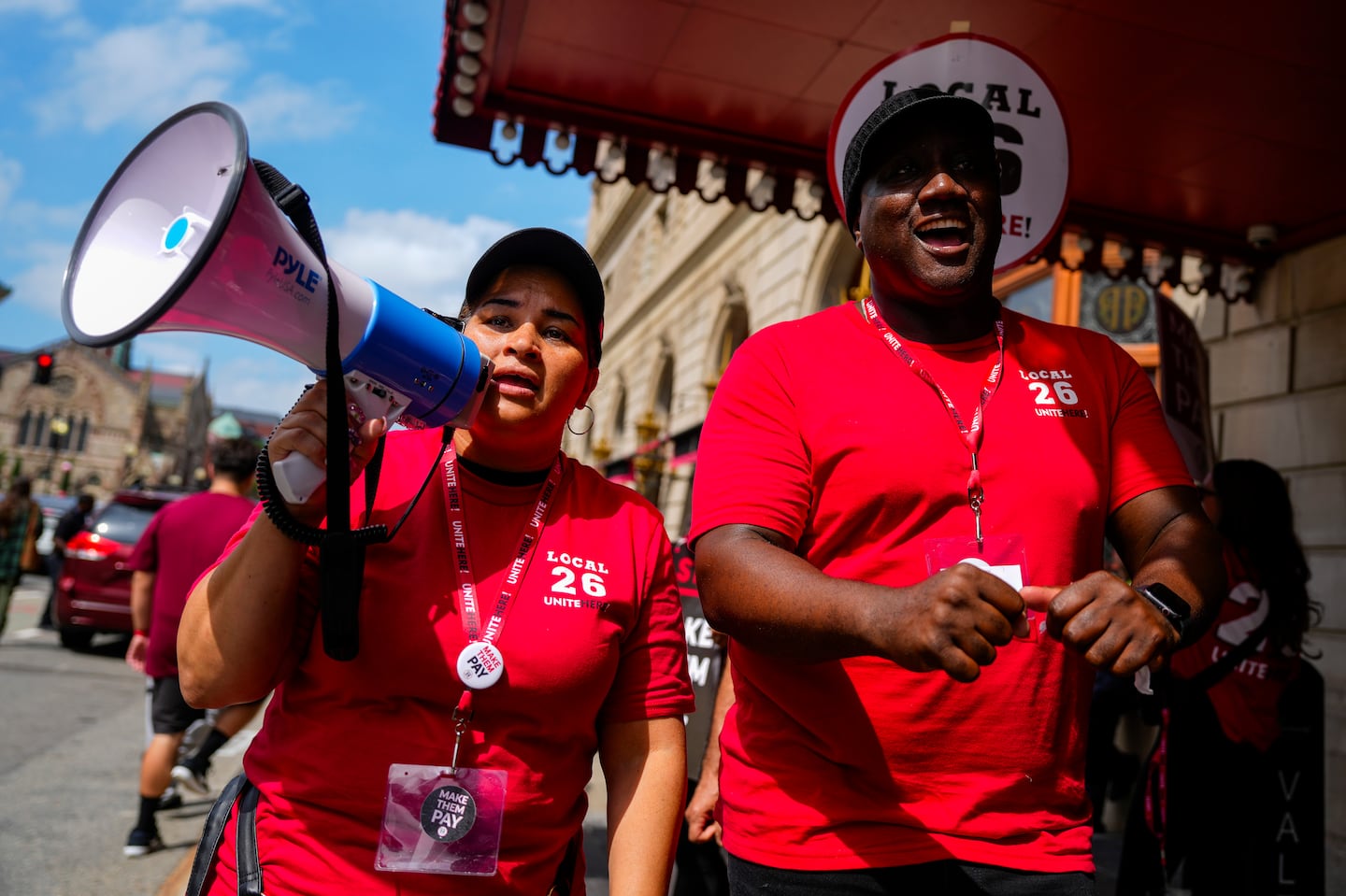 Keila Matias (left) and Alpheus Caine marched in front of the Fairmont Copley Plaza during the first round of strikes last month.