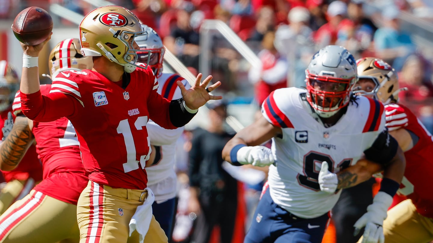 49ers quarterback Brock Purdy (left) had a lot of time to operate in and out of the pocket against the Patriots.