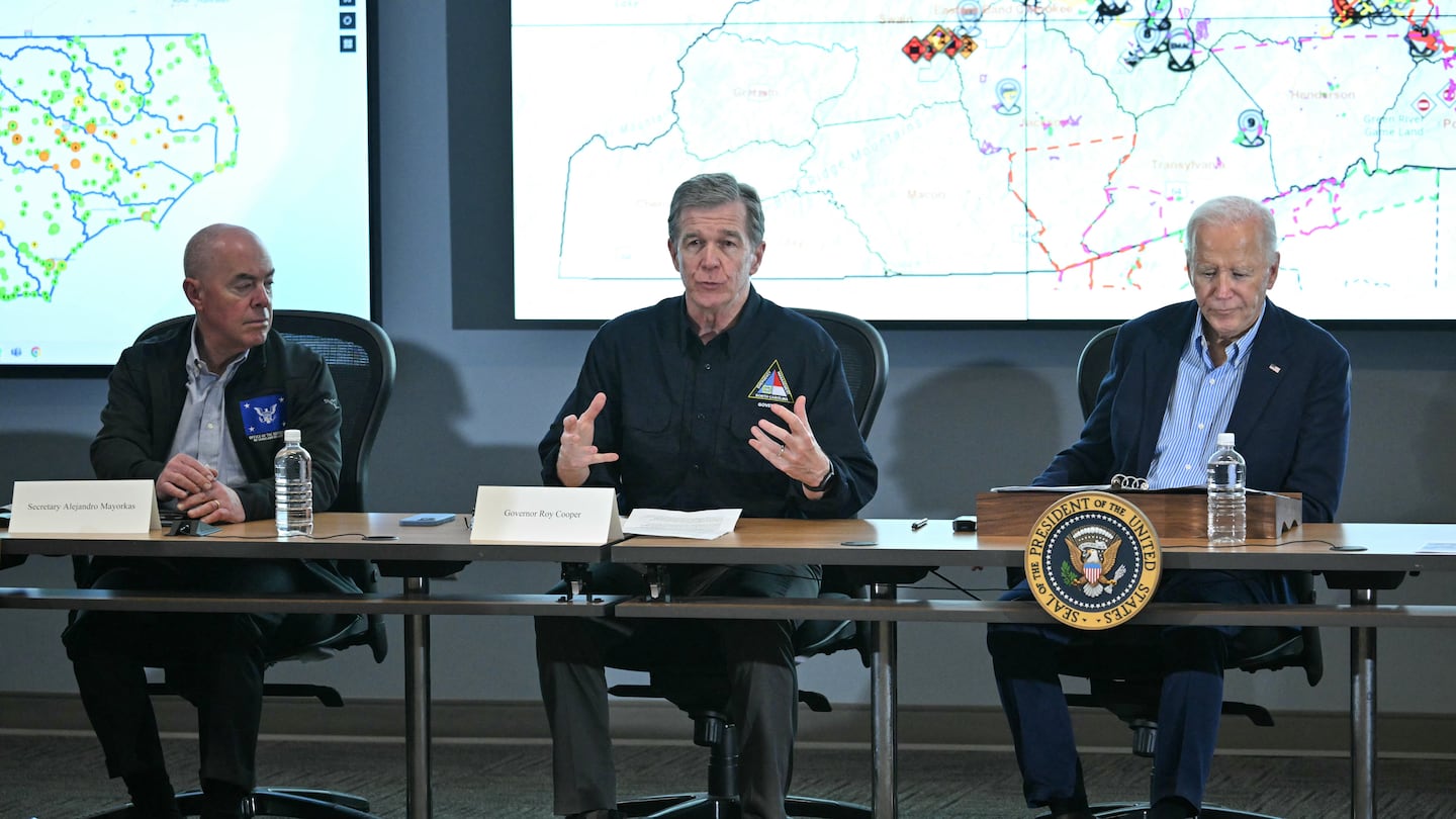 North Carolina Governor Roy Cooper (C) speaks as President Biden (R) and US Secretary of Homeland Security Alejandro Mayorkas (L) listen during an Operational Briefing at Raleigh Emergency Operations Center following the passage of Hurricane Helene, in Raleigh, North Carolina.