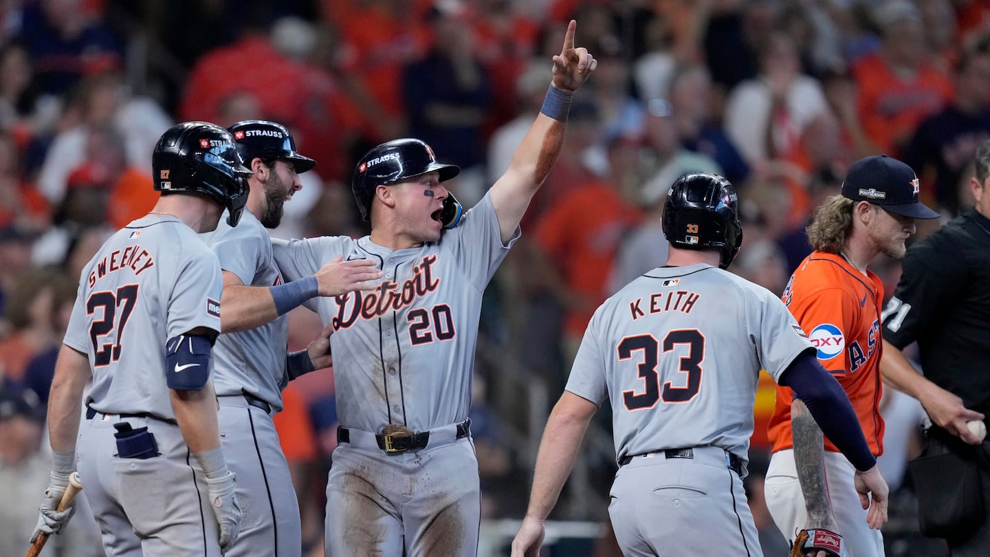 Trey Sweeney (27), Matt Vierling (left rear), Spencer Torkelson (20), and Colt Keith (33) celebrate after Torkelson, Keith and Vierling scored on Andy Ibáñez's double off Astros star reliever Josh Hader (right) in the eighth inning, powering Detroit to a wild card series sweep  Wednesday in Houston.