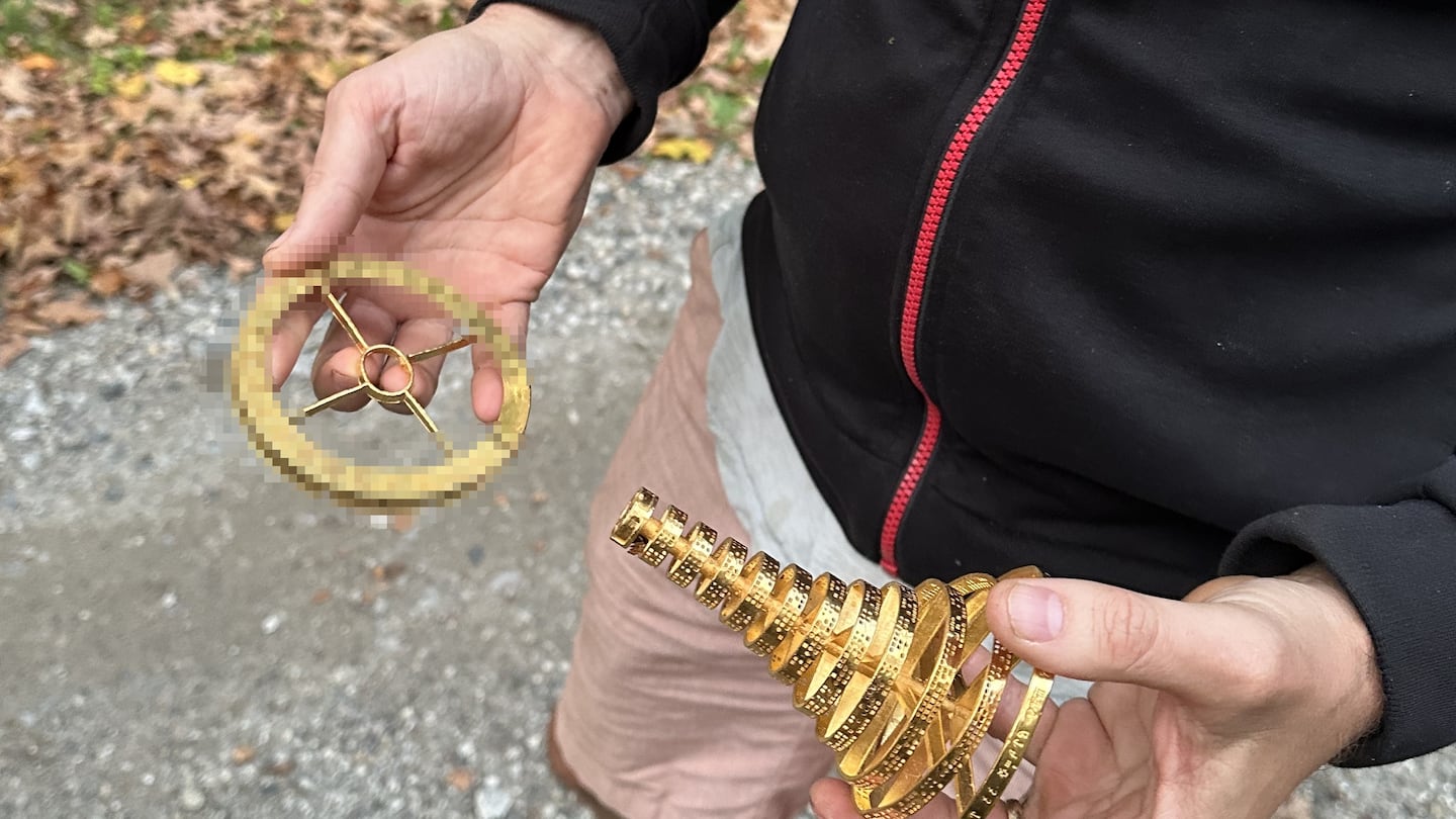 The unnamed winner of Project Skydrop, above, holding the precious cargo following his discovery. The bottom half of the trophy, which contains a code that can be used to claim a Bitcoin wallet valued at $87,000, has been blurred out. The man told people he has no intention of claiming the Bitcoin, and was just interested in the thrill of the hunt.