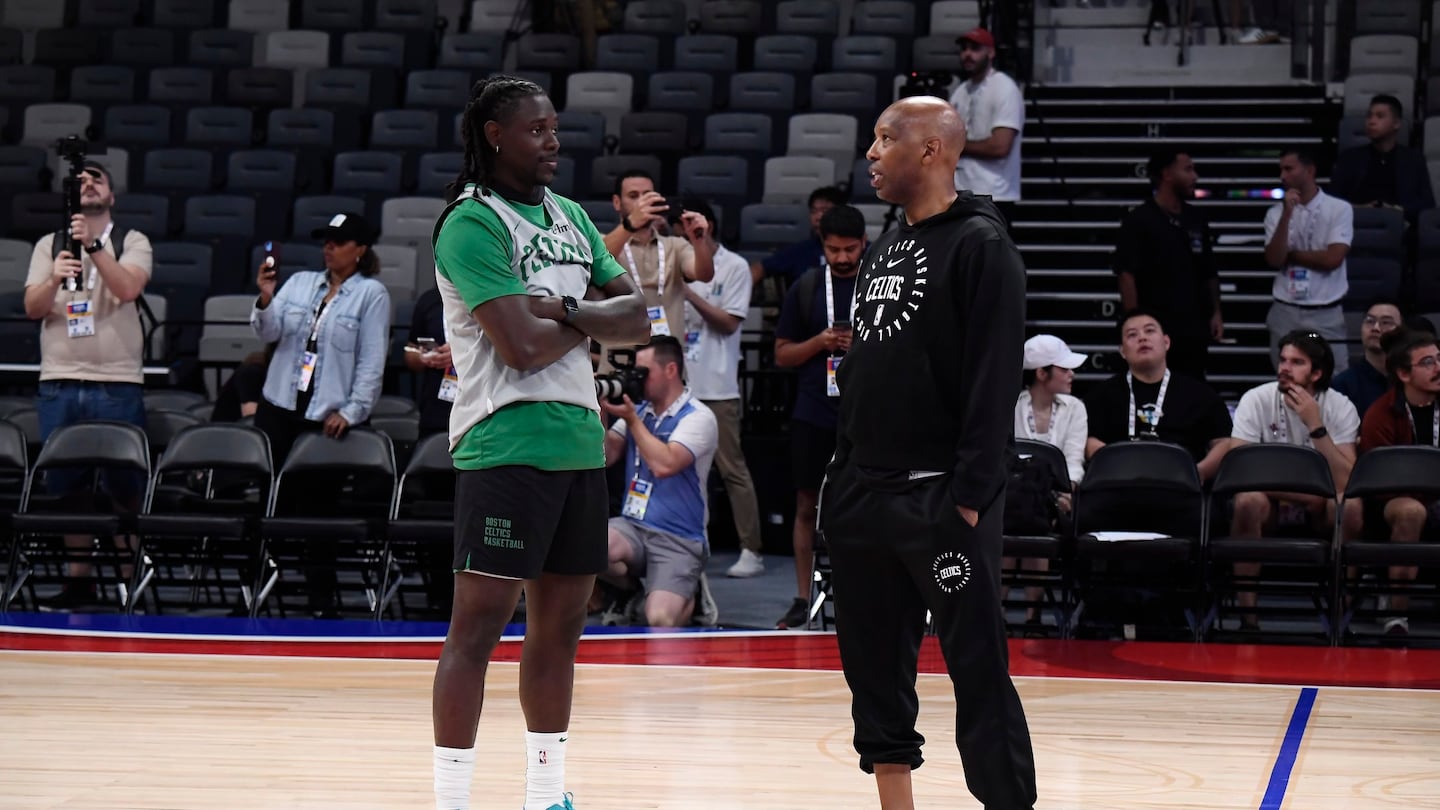 Jrue Holiday (left) and assistant coach Sam Cassell at a Celtics practice in Abu Dhabi.