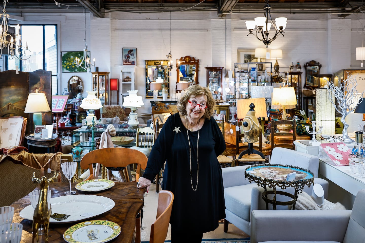 Ann Orcutt, owner of AnnTiques in Ipswich, surrounded by antiques and collectibles in her store. The antique shop was used as a key setting for the new adaptation of Stephen King's "'Salem's Lot," and closed for five months during production.