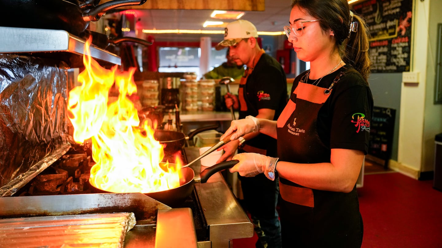 Jose Villafranca (left), owner of the Peruvian Taste restaurant in Charlestown, and manager Yoana Pleitez did some cooking. The restaurant has been unable to afford the high cost of a liquor license.