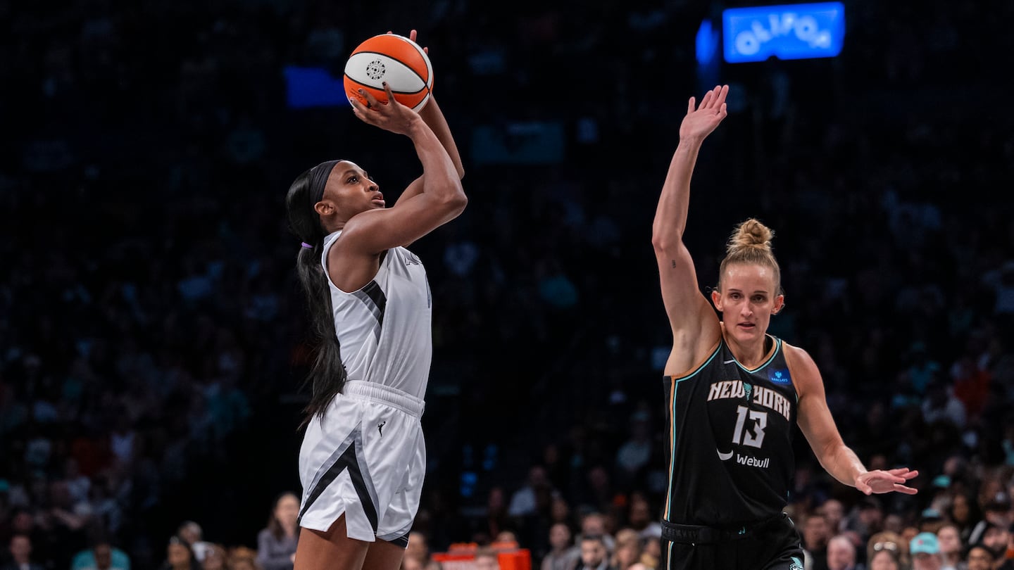 Las Vegas Aces guard Jackie Young (0) shoots over New York Liberty forward Leonie Fiebich (13) during the second half of a WNBA basketball semifinal game, Sunday, Sept. 29, 2024, in New York. (AP Photo/Corey Sipkin)